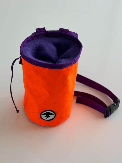 Orange and purple chalk bag on a white background